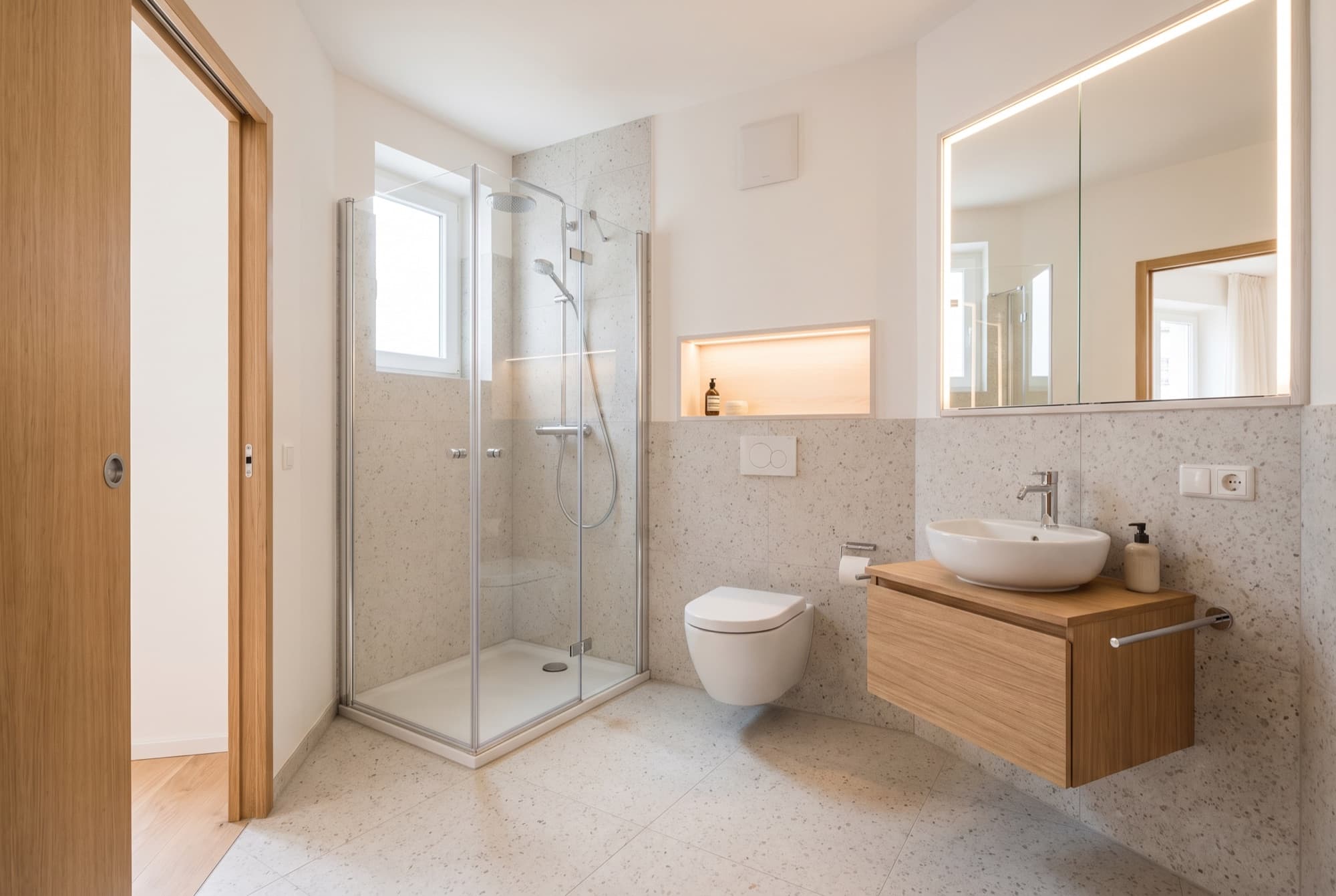 Kleines, frisch saniertes Bad mit Eckdusche, Vorwand-WC und Spiegelschrank